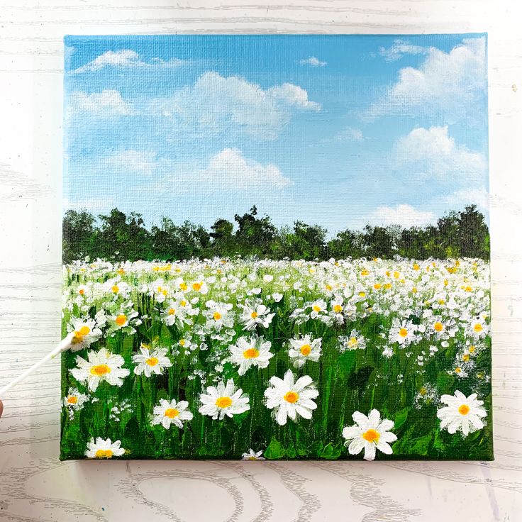 A painting of white daisy field with blue sky and fluffy clouds on green landscape Natural Painting Easy, Acrylic Painting Canvas Acrylic Painting Canvas Landscapes, Easy Flower Landscape Painting, Field Of Daisies Drawing, Daisy Field Drawing, Flower Scenery Painting Easy, Diy Daisy Painting, Field With Flowers Painting, Nature Painting For Beginners