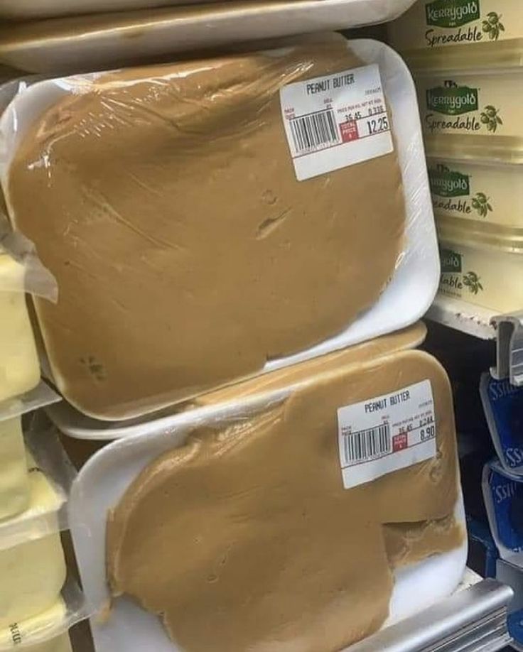 there are two trays of peanut butter on the shelf in the store for sale