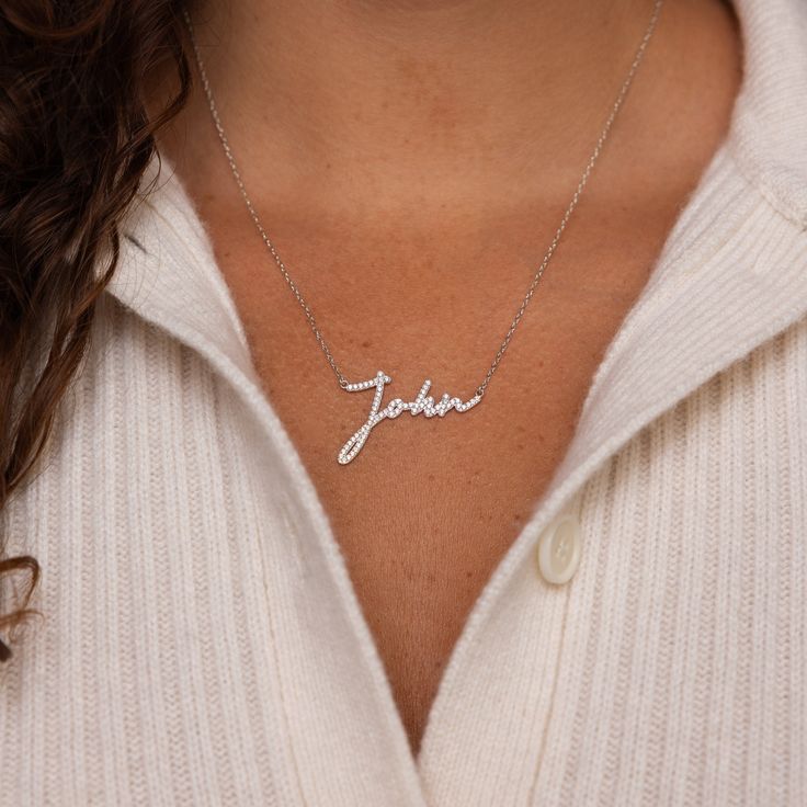 Let meaningful handwriting from a loved one become memorialized with our Pave Handwriting Necklace. This diamond necklace is not only sentimental but also a statement jewelry piece to show the importance of the handwriting being showcased. SKU: MM-NM77 Product Details Material: High Quality Solid 925 Sterling Silver Finish: Sterling Silver ∙ 18K Gold ∙ Rose Gold Size: The total necklace length includes the chain + charm (ex. chain + charm =18"). Necklace also comes with a 1" extension chain so y Signature Silver Jewelry With Names, Meaningful Nameplate Necklaces For Anniversary, Meaningful Name Necklaces For Anniversary, Meaningful Nameplate Necklace For Anniversary, Meaningful Anniversary Name Necklaces, Signature Necklaces For Anniversary And Mother's Day, Meaningful Silver Custom Name Necklace, Signature Sterling Silver Name Necklace For Anniversary, Meaningful Sterling Silver Name Necklace