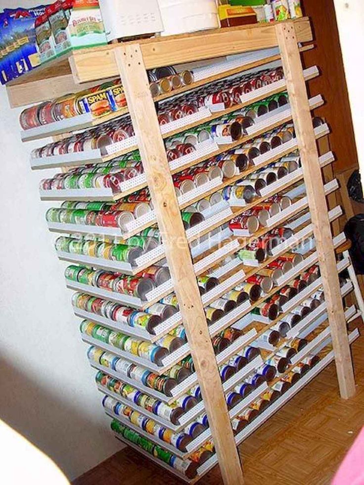 an organized pantry with canned food and drinks on the bottom shelf is shown in this image