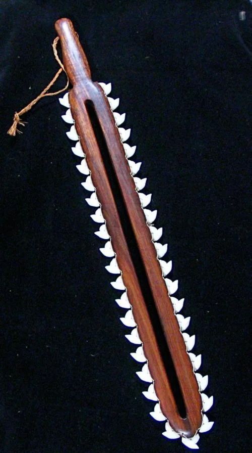 a wooden object with spikes on it sitting on a black cloth covered tablecloth,