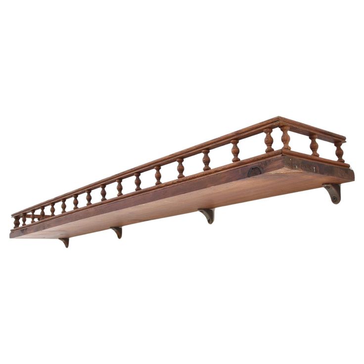 a wooden shelf with two brackets on it