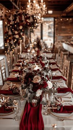 the table is set with red and silver place settings