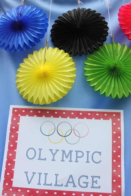 the olympic village sign and paper fan decorations