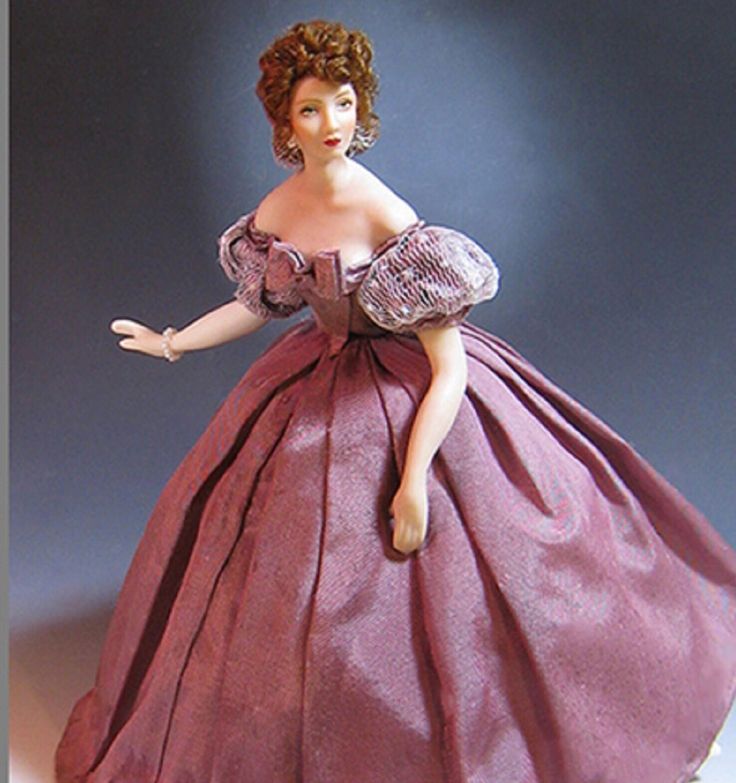 a figurine of a woman in a pink dress