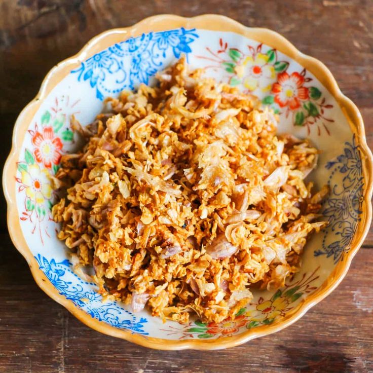 a bowl filled with food sitting on top of a wooden table