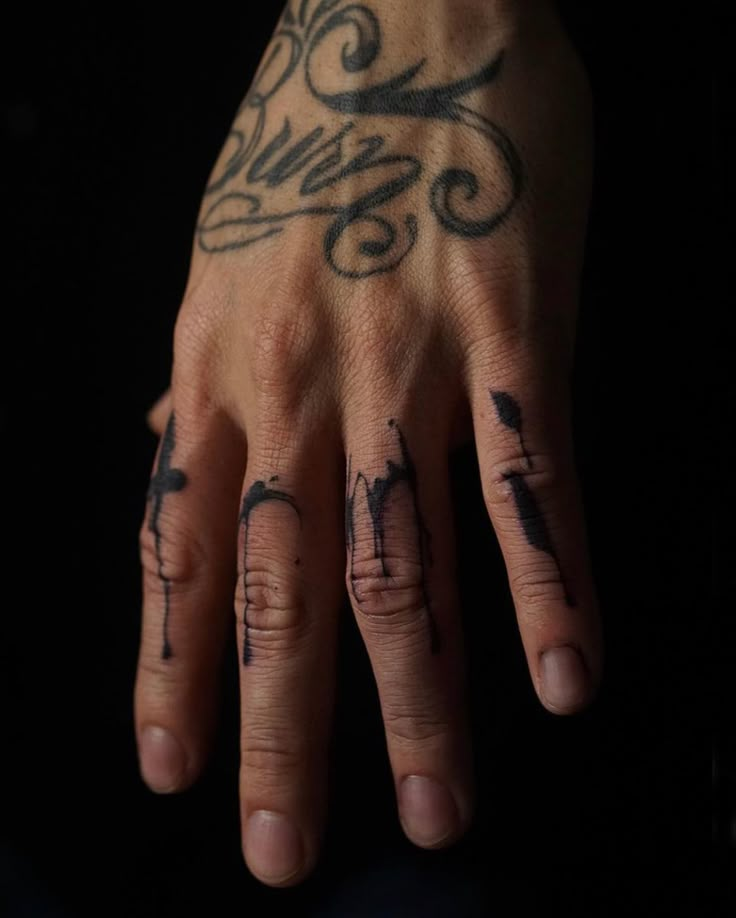 a person with tattoos on their hands and fingers