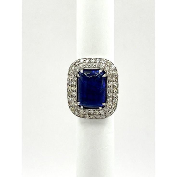 This is part of Chairish’s Fine Jewelry assortment.  Gorgeous big size tanzanite rectangular cabochon with good quality white diamond rounds.  Handmade in 18k white gold.  This ring was bought in a large lot so accurate weights are unknown but close approximation can be given in message.  Ring size 7.25. Luxury Rings With Diamond Accents And Rectangular Stone, Luxury Rings With Rectangular Diamond Accents, Luxury Diamond Ring With Rectangular Stone, Formal Octagon Sapphire Ring In Platinum, Luxury Emerald-cut Sapphire Ring With 17 Jewels, Luxury Rings With Rectangular Center Stone, Luxury Square Cut Sapphire Ring, Luxury Rings With Center Stone And Rectangular Shape, Rectangular Sapphire Ring For Formal Occasions