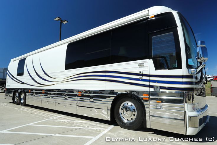 a large white bus parked in a parking lot