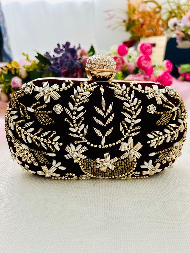 Elevate your style with our exquisite handmade handbags, meticulously crafted with intricate embroidery and stunning handwork. Each piece is a work of art, blending traditional craftsmanship with modern elegance. Make a statement with a handbag that's as unique as you are. Shop now and add a touch of luxury to your wardrobe!  Comes with gold shoulder chain. Limited stock available and can be made on orders in 4-6 weeks. Reach out to us for any customization and color options. Hand Embellished Pouch Bag For Reception, Hand Embellished Bags For Reception, Embellished Pouch Bag For Reception, Elegant Hand Embellished Black Bag, Elegant Black Hand-embellished Bag, Elegant Black Hand-embellished Clutch, Elegant Black Hand Embellished Clutch, Luxury Embellished Potli Bag For Evening, Luxury Embroidered Festive Bags