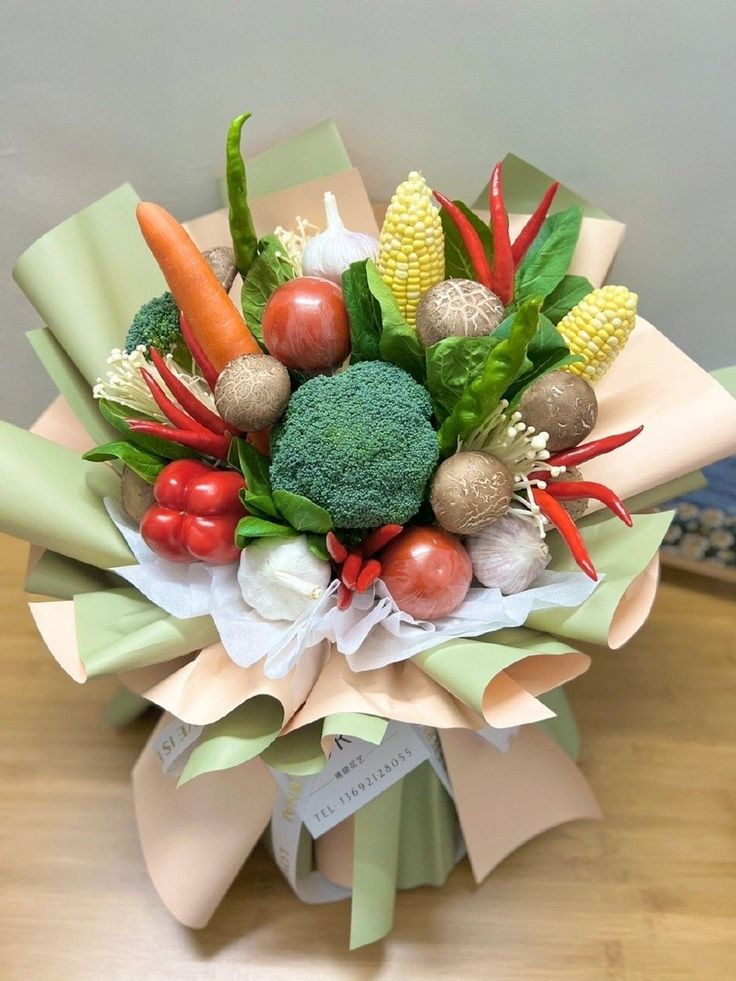 a bouquet of vegetables and fruits is sitting on a table