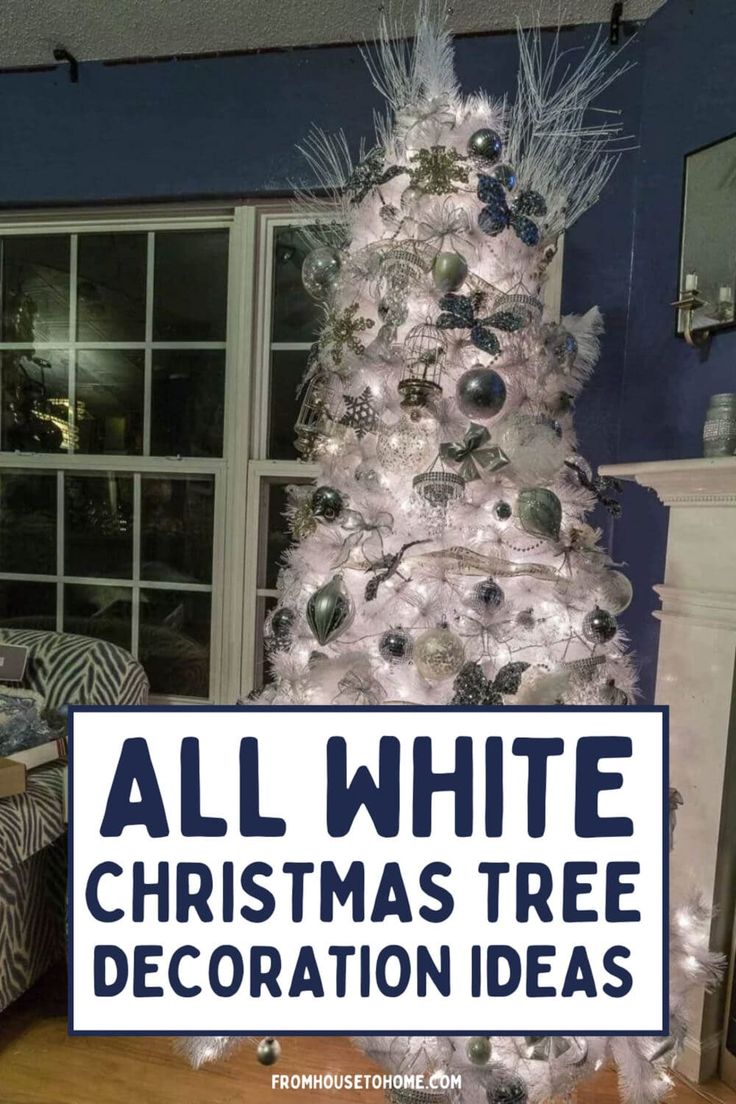 a white christmas tree decorated with black and silver ornaments