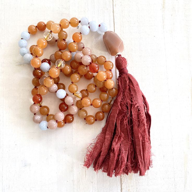 "A wonderful Mala for helping with insecurities. Handcrafted with Aquamarine for support when feeling overwhelmed and Peach Aventurine for assistance when making decisions. This Mala also consists of Sunstone which is known as a stone of leadership and personal power along with Carnelian to calm temper and give a sense of humor. An accent stone of Citrine is worked in for joy and happiness. All these healing stones are hand knotted into this beautiful 108 bead Mala. Charm not included, please se Handmade Spiritual Coral Beaded Necklaces, Handmade Coral Beaded Necklaces For Spiritual Use, Handmade Coral Beaded Necklaces Spiritual Style, Aventurine Gemstone Beads Necklace For Healing, Spiritual Amber Beaded Necklaces With Natural Stones, Spiritual Amber Beaded Necklace With Natural Stones, Amber Beaded Necklace For Meditation, Hand-strung Orange Beads As A Gift, Carnelian Beaded Bracelets With Natural Stones For Meditation