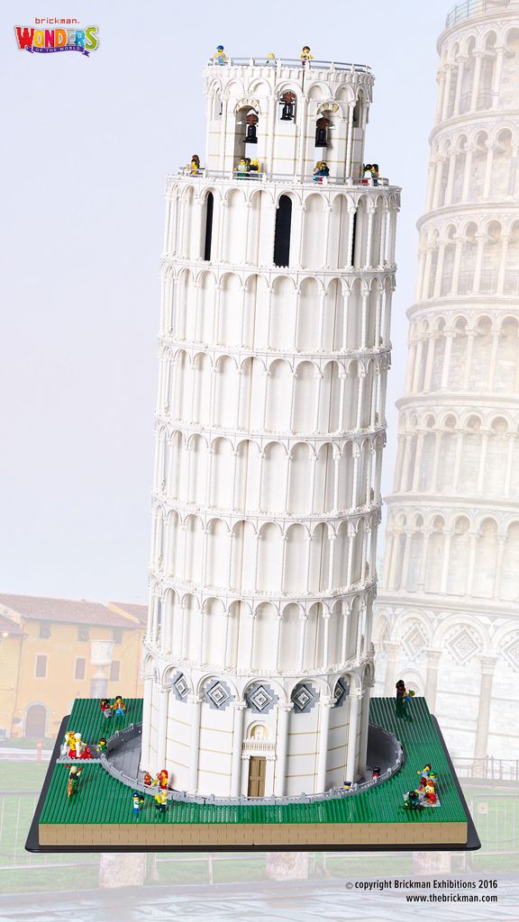 a lego model of the leaning tower of pisa, with people inside and around it