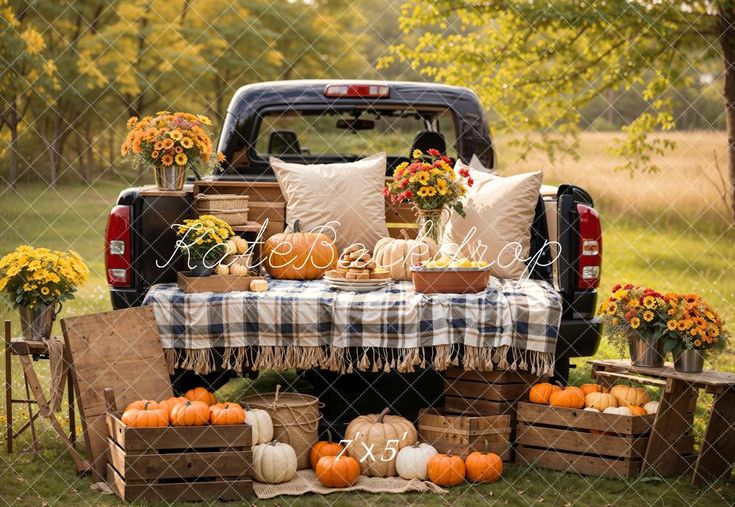 the back of a pickup truck filled with pumpkins and other fall decorating items