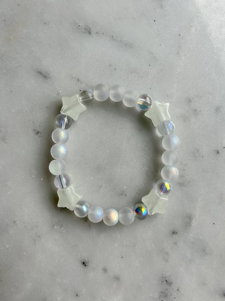 White and clear bracelet with stars around it's made with stretchy string! One size fits all. White Bracelet Aesthetic, Bracelet Aesthetic, Clear Bracelet, Mini Bracelet, White Bracelet, White Bracelets, Star Bracelet, Bead Bracelets, One Size Fits All