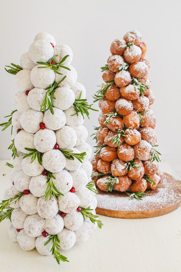 two christmas trees made out of donuts and sprinkled with powdered sugar