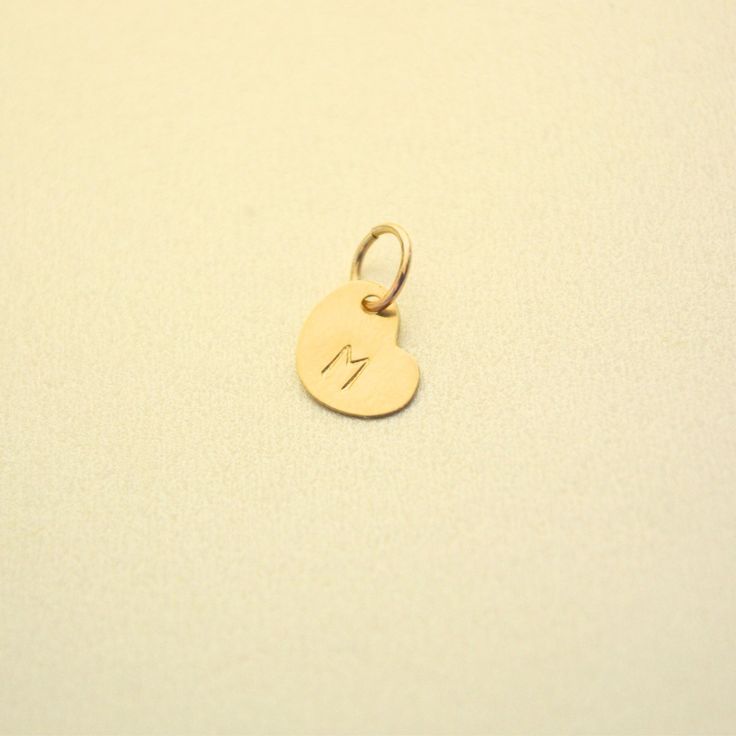 Elevate your personalized necklace collection with our Heart shape charm. This charming addition is the perfect complement to any version of our Personalized Disc Necklace 1/2", 3/4" and Tag Necklaces, adding a touch of love and individuality. Handcrafted in the USA. DETAILS: Skin Friendly Material: 14/20 gold filled Dimensions: 6.4mmx8.2mm ALL LETTERS ARE CAPITAL - Use the Personalized Box Above to write down your letter, in case you're shopping through Instagram Shop use "Order Notes" in the cart. *This listing is for a single Heart add-on (no chain). Our heart charm comes attached to a jump ring. Due to the unique, handmade nature of this piece, it may not be compatible with other bracelets or necklaces. Have questions? Our customer care team can help you. Email us at contact@almalibrej Heart Pendant Charm Necklace As Gift For Mom, Heart Charm Necklace For Mom With Round Pendant, Charm Necklace With Heart Pendant For Mom, Heart Charm Round Pendant Necklace As Gift For Mom, Heart Charm Necklace Gift For Mom, Personalized Initial Pendant Charms For Gifts, Personalized Initial Pendant Charms As Gift, Personalized Dainty Initial Pendant Charms, Dainty Personalized Initial Pendant Charms