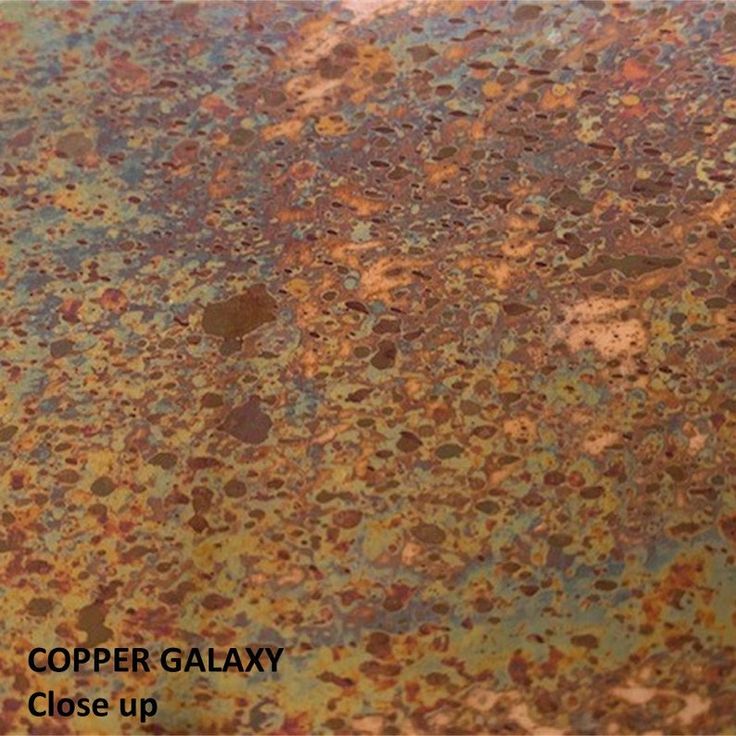 an old rusted metal surface that has been scratched and chipped with the words copper galaxy close up on it