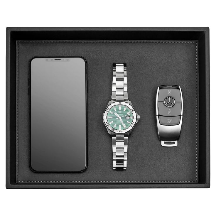 a watch, cell phone and other items in a black box on a white background