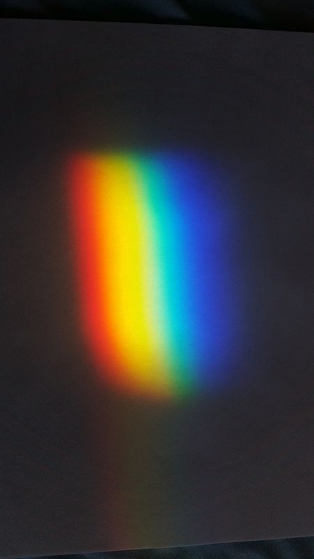 an image of a rainbow light coming out of the center of a square shape window