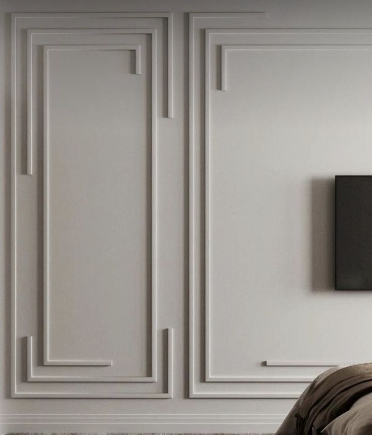 a bedroom with white walls and beige furniture