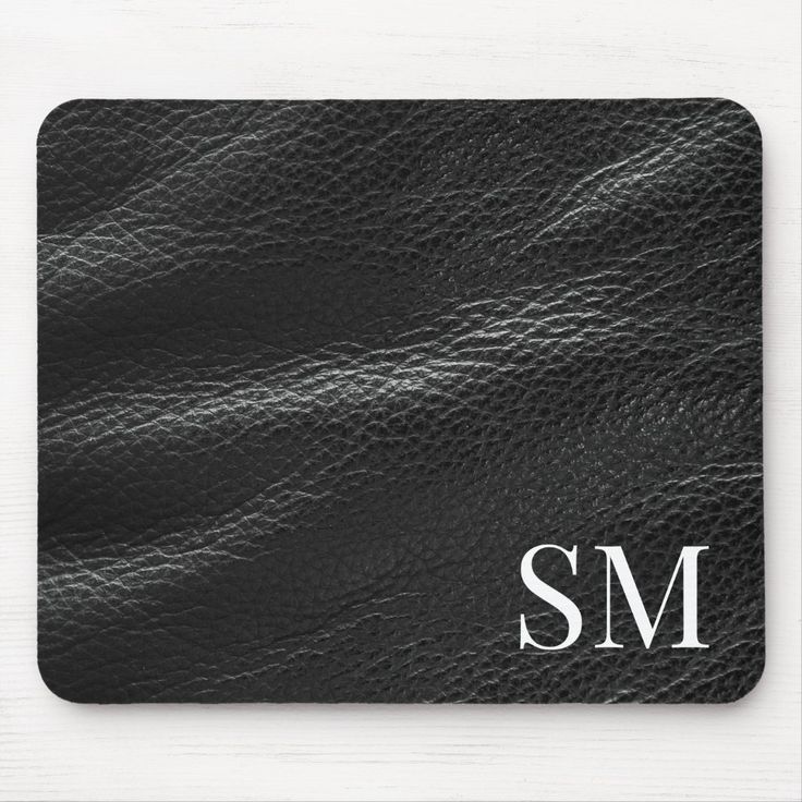 a black leather texture with the letter s m mousepad on it's side