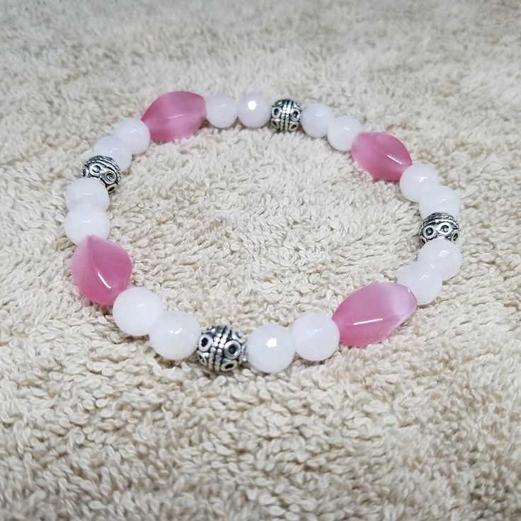 Rose Quartz Pink Cat's Eye Stretch Bracelet This bracelet was made with beautiful 8 mm rose quartz beads and pink cat's eye beads. This is a beautiful bracelet that will promote unconditional love. This bracelet is also easy to put on and take off. Beautiful on it's own or layer with other bracelets. So pretty, you will want to wear it everyday! * The fair and lovely Rose Quartz, with its gentle pink essence, is a stone of the heart, a Crystal of Unconditional Love. It carries a soft feminine en Pink Rose Quartz Round Stretch Bracelet, Pink Rose Quartz Stretch Bracelet, Adjustable Pink Charm Bracelet With 8mm Beads, Rose Quartz Round Beads Bracelet For Valentine's Day, Pink Beaded Bracelets With 8mm Beads For Birthday, Adjustable Pink Rose Quartz Stretch Bracelet, Pink Rose Quartz Stretch Bracelet With 8mm Beads, Rose Quartz Beaded Bracelet With Faceted Beads As Gift, Pink Stretch Bracelet With Faceted Beads For Gift