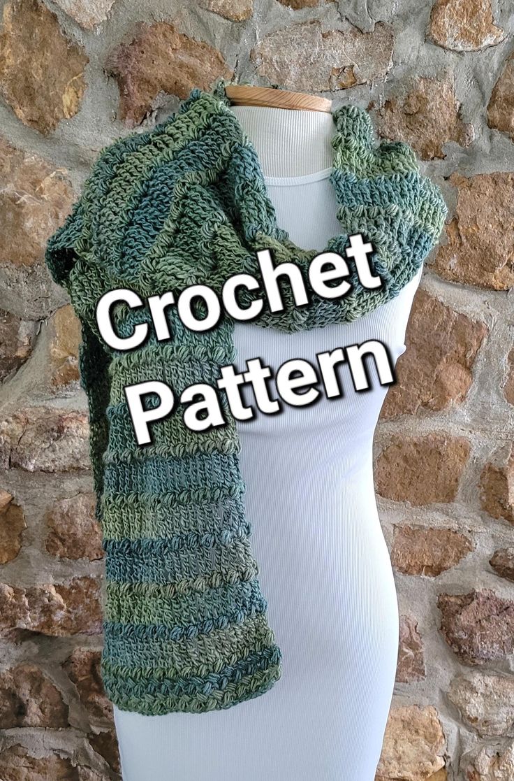 a white mannequin wearing a green knitted scarf with the words crochet pattern on it