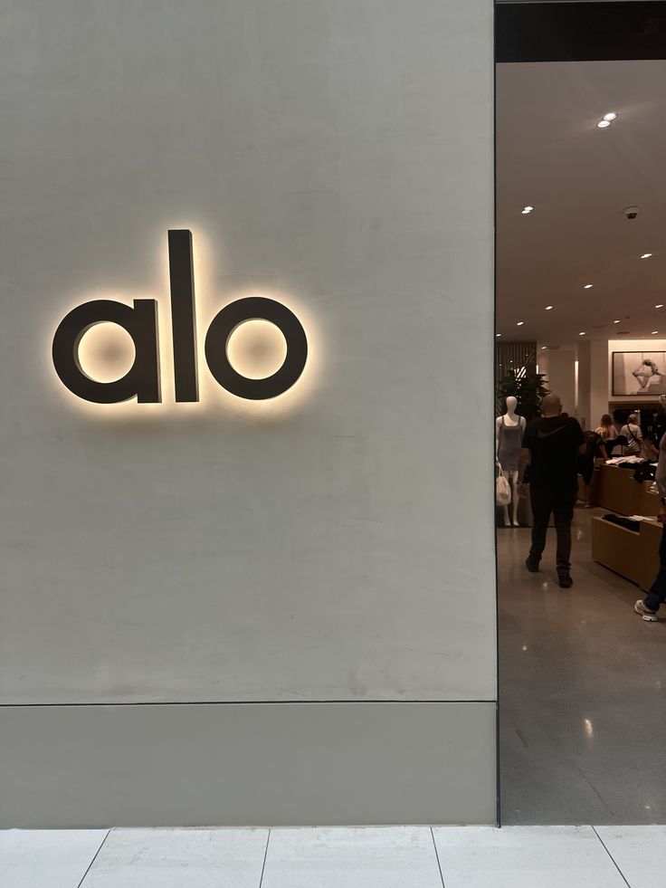 the entrance to an alo store with people walking by