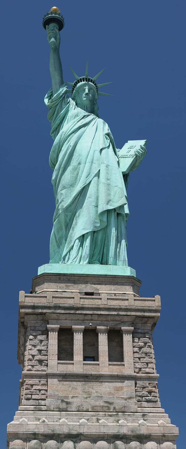 the statue of liberty is shown against a blue sky