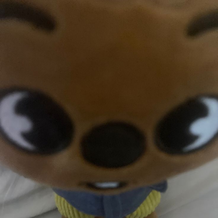 a close up of a stuffed animal with big eyes