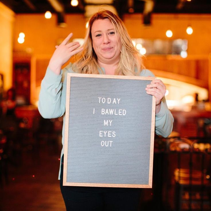 a woman holding up a sign that says today i be called my eyes out in front of her