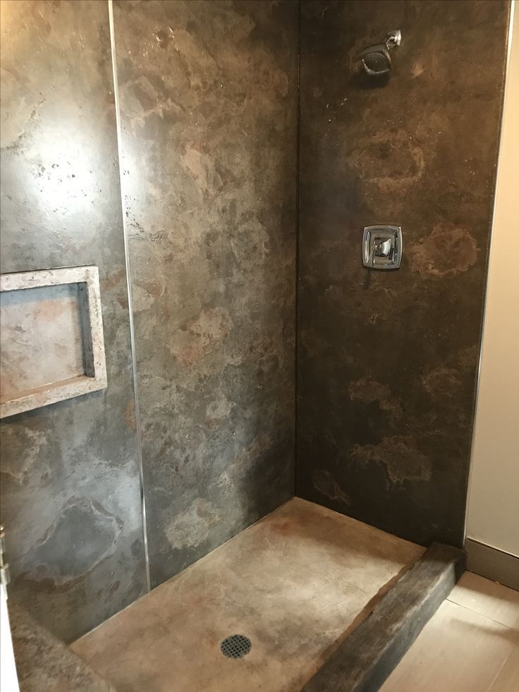 a walk in shower sitting inside of a bathroom next to a wall mounted faucet