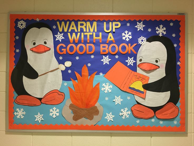 a bulletin board with penguins and a fire in the middle that says warm up with a good book