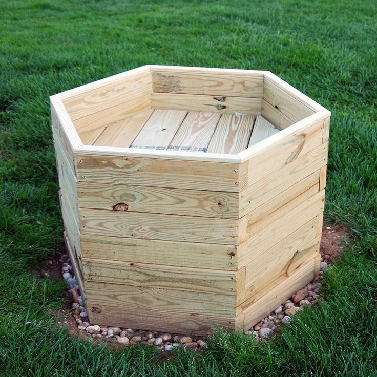 a wooden box sitting on top of a lush green field