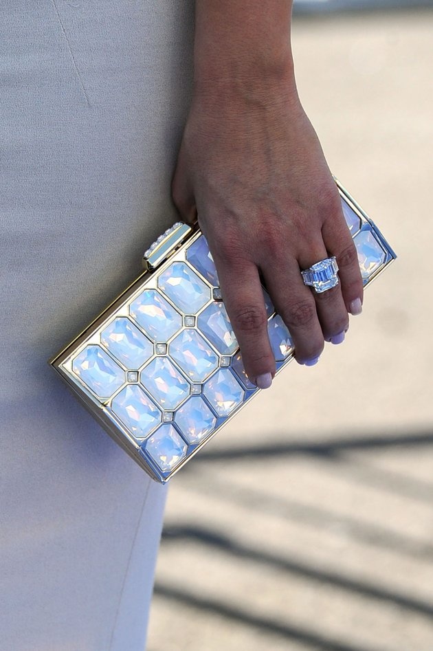 a close up of a person holding a purse with its hand on the other side