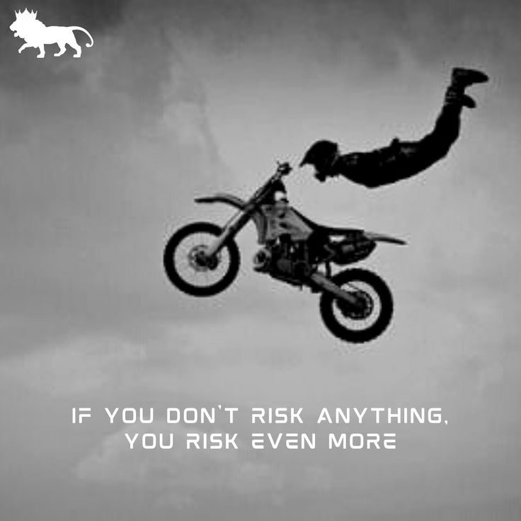 a man flying through the air on top of a dirt bike in front of a cloudy sky