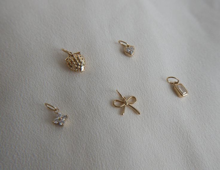 Solid 14k Gold Charms: -Strawberry Dimensions: 10mm -Heart with Moissanite Dimensions: 5mm -Flower with Moissanite Dimensions: 6mm -Bow Dimensions: 8mm -Emerald Cut Moissanite Dimensions: 5mm Elegant 14k Gold Heart Charm, Gold Charms With Diamond Accents As Gifts, Gold Charms With Diamond Accents For Gifts, Elegant Rose Gold Charms For Anniversary, Elegant Anniversary Charms, Diamond Charms With Diamond Accents For Gifts, Yellow Gold Diamond Charms As Gift, Elegant Yellow Gold Charms For Gifts, Elegant Heart Shaped Charms For Gifts