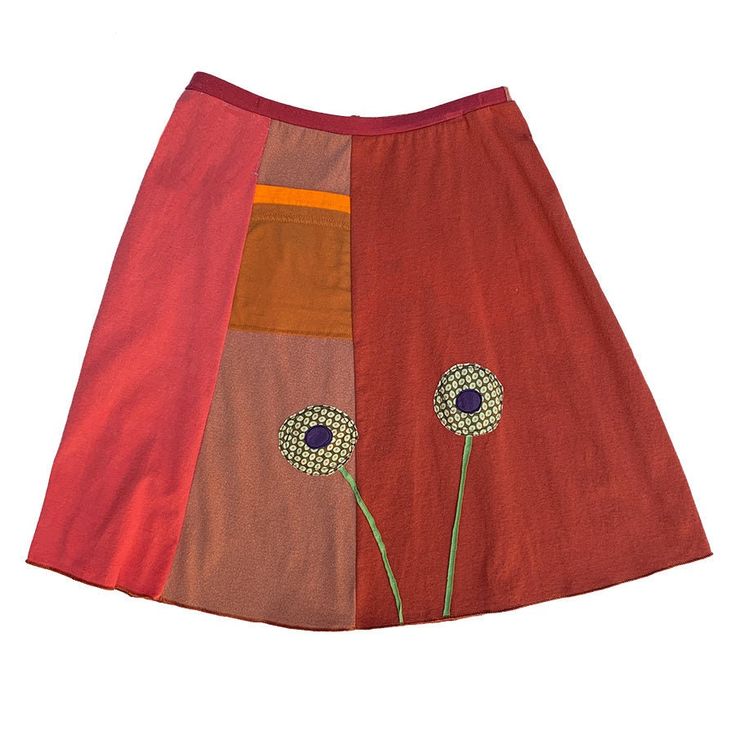 a red skirt with two flowers on the front and one flower on the back, all in different colors