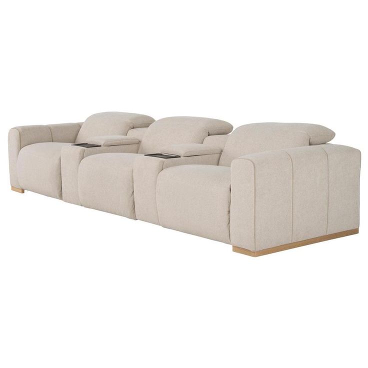 a large beige couch with pillows on it's back and side ends, in front of a white background