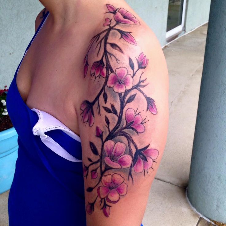 a woman's arm with flowers on it