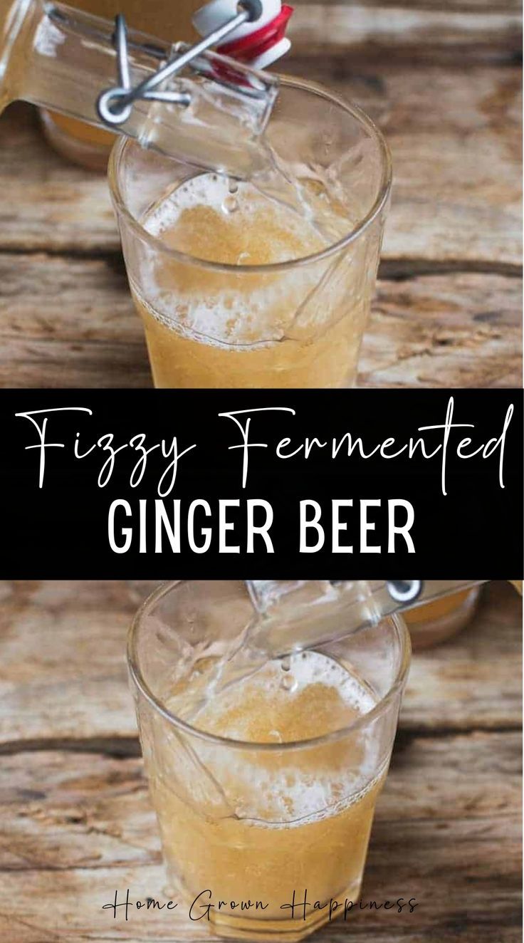 two glasses filled with ginger beer sitting on top of a wooden table