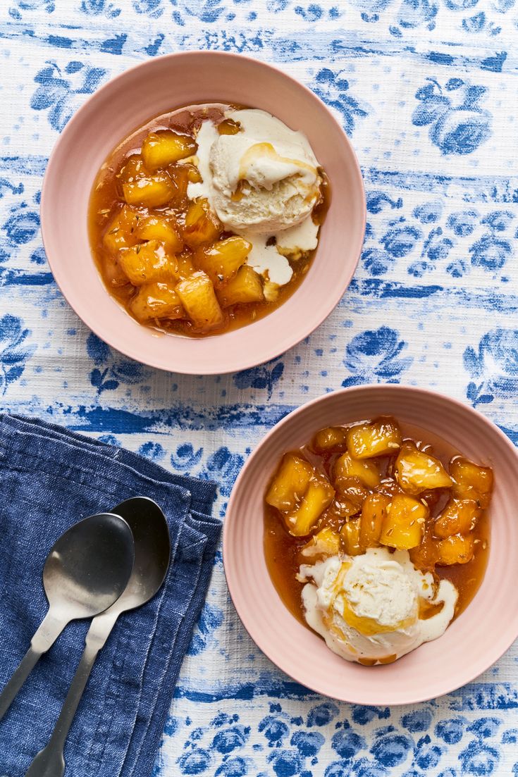 two bowls filled with stew and ice cream on top of a blue floral table cloth