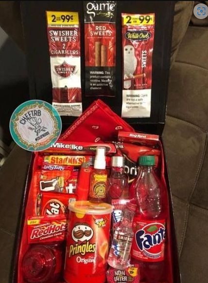 an open suitcase containing drinks, snacks and other condiments on the seat back