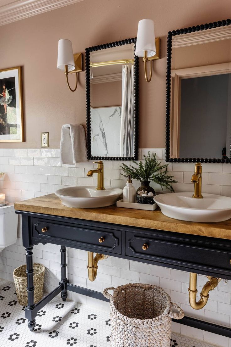 a bathroom with two sinks and mirrors on the wall