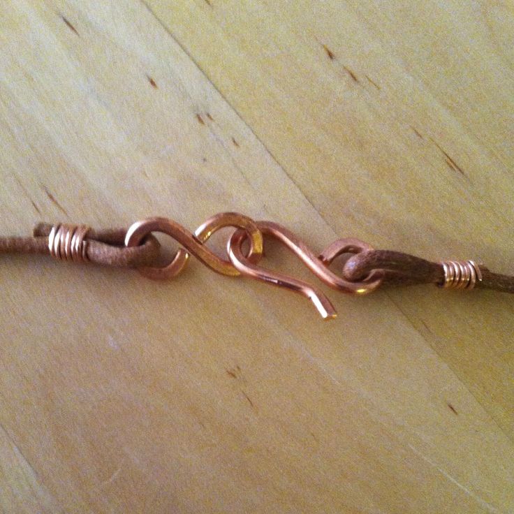 a wire wrapped in copper sitting on top of a wooden table