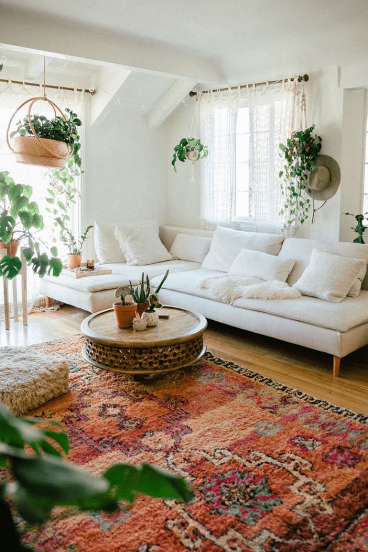 a living room filled with furniture and plants