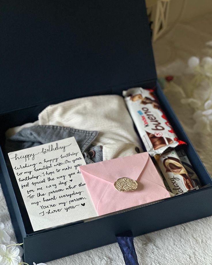 an open box with some items in it and a note attached to the top lid