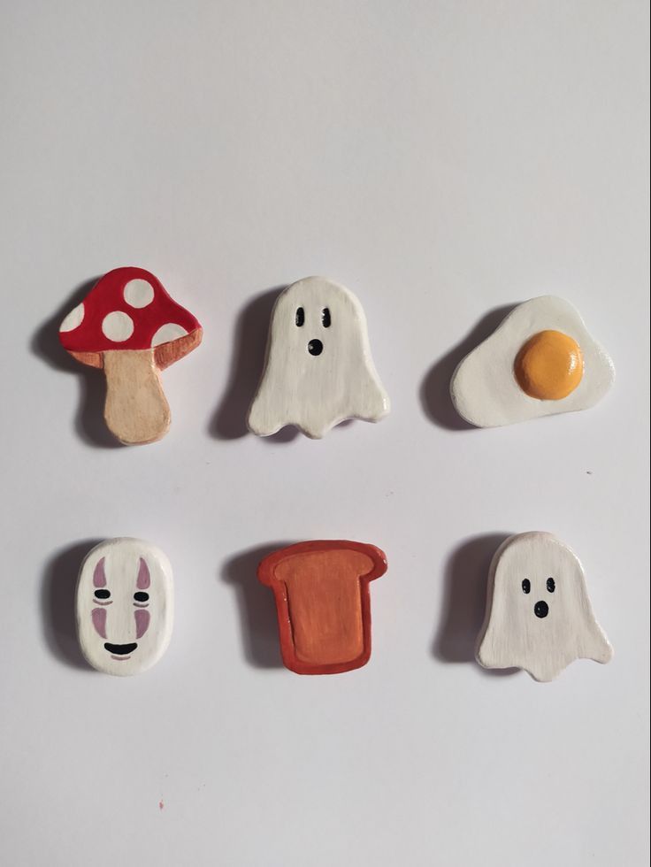 four different types of food are arranged in the shape of eggs, mushrooms, and ghost faces